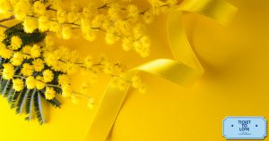 Comunicato Stampa di Ticket To Love per la Festa della Donna: nell'immagine una mimosa con fiocco giallo
